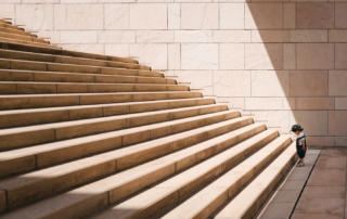 toddler's standing in front of beige concrete stair