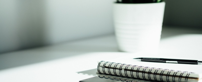 pen, notebook, and smartphone on table