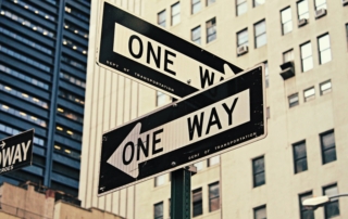 white and black One Way-printed road signages