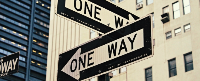 white and black One Way-printed road signages