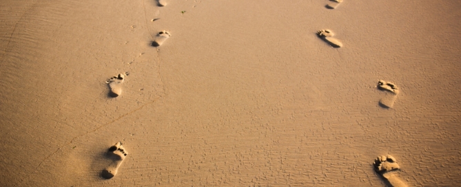 foot prints on brown sand